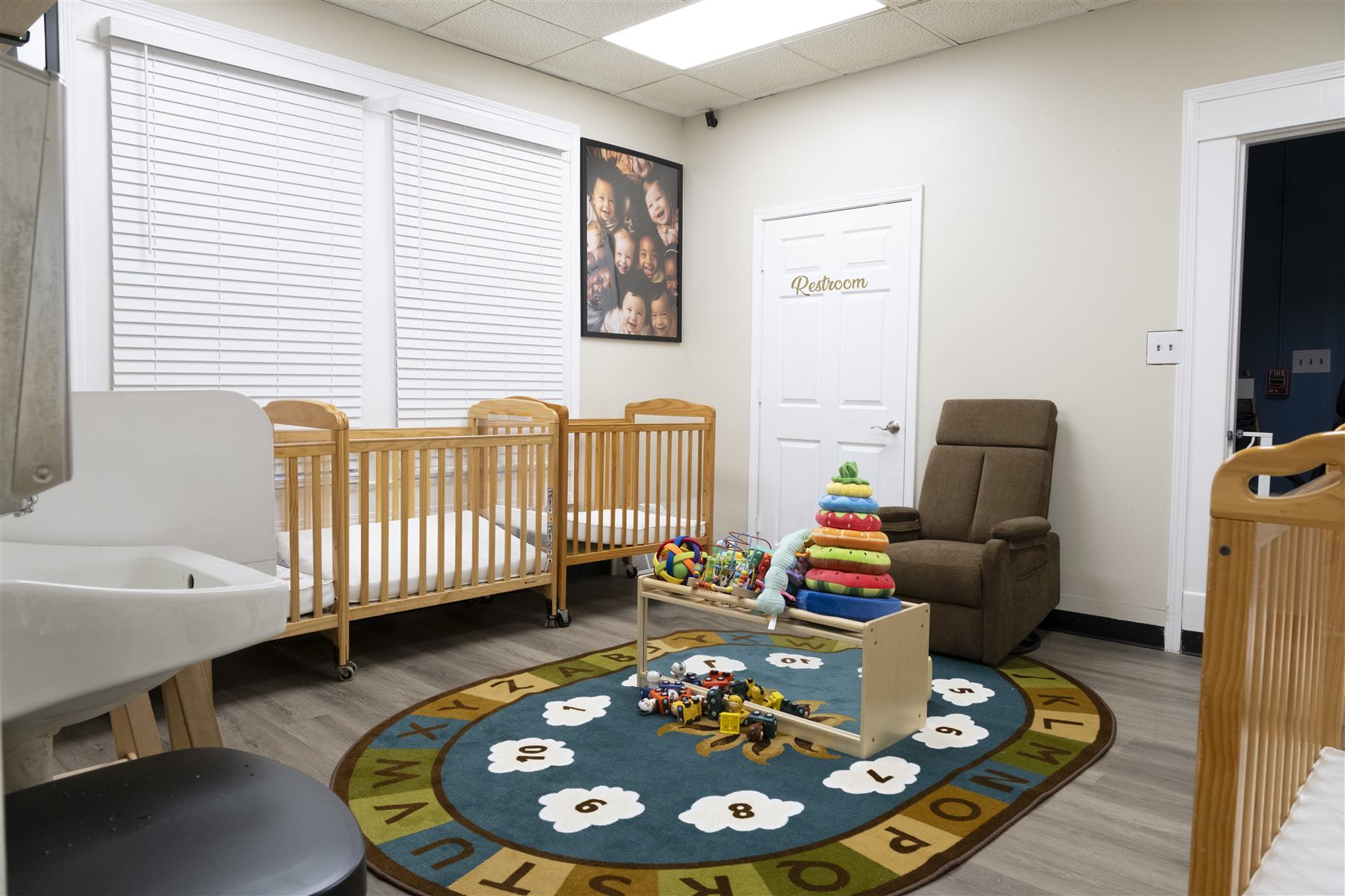 Infant nursery with cribs and soft play area