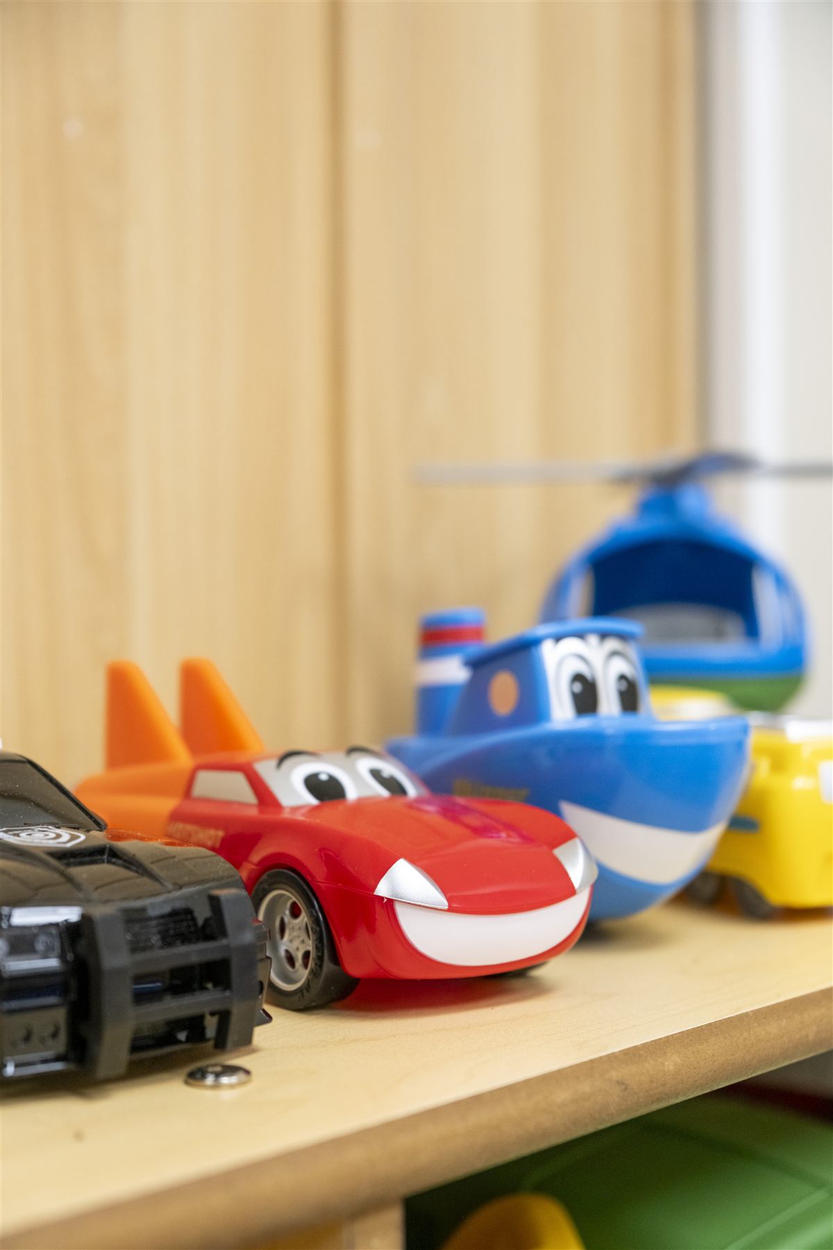 Toy cars lined up on a shelf